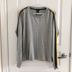 Grey long tee shirt with yellow stripes on sleeve